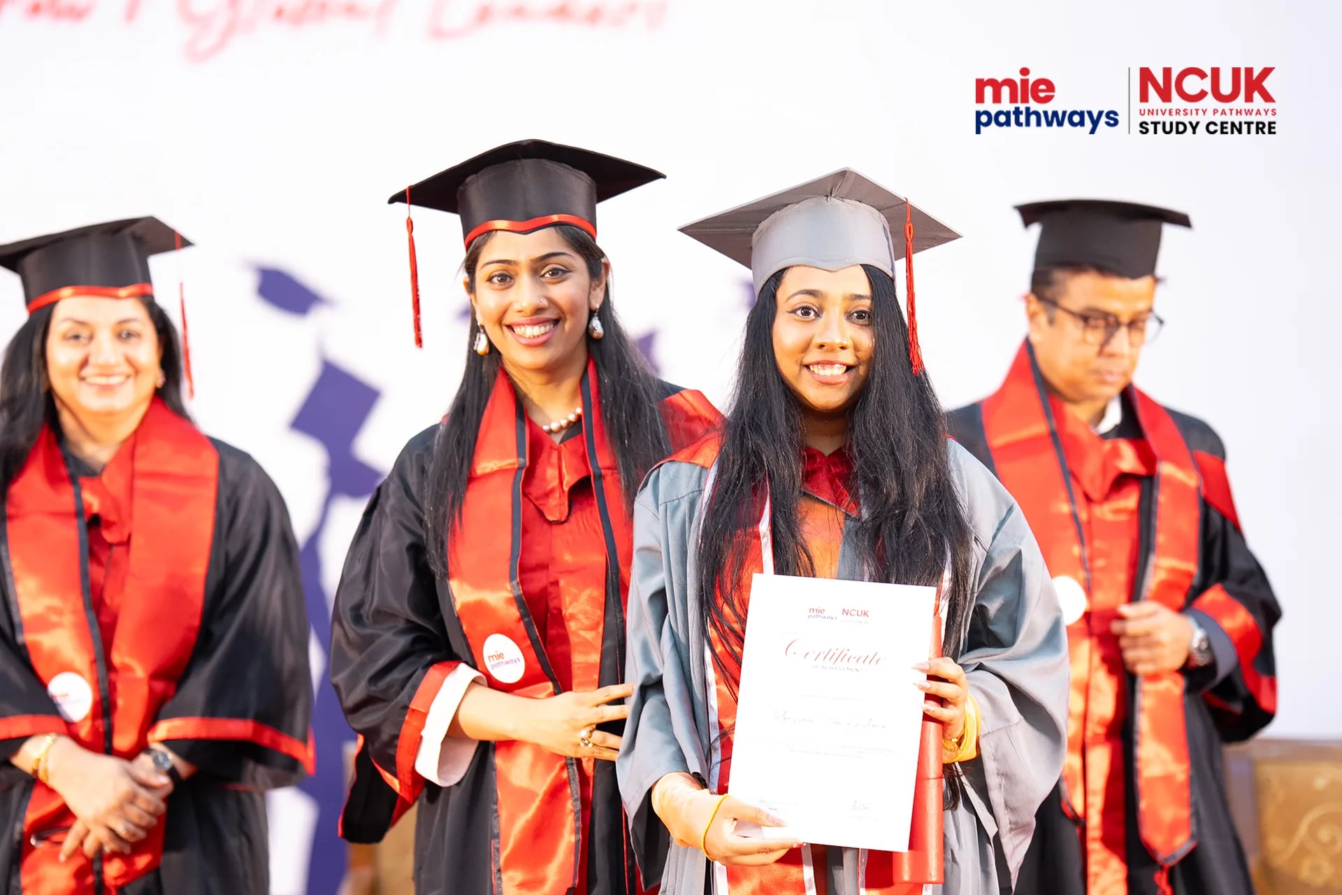 Graduates receiving their certificates at the NCUK Graduation Ceremony 2026 — photo 1