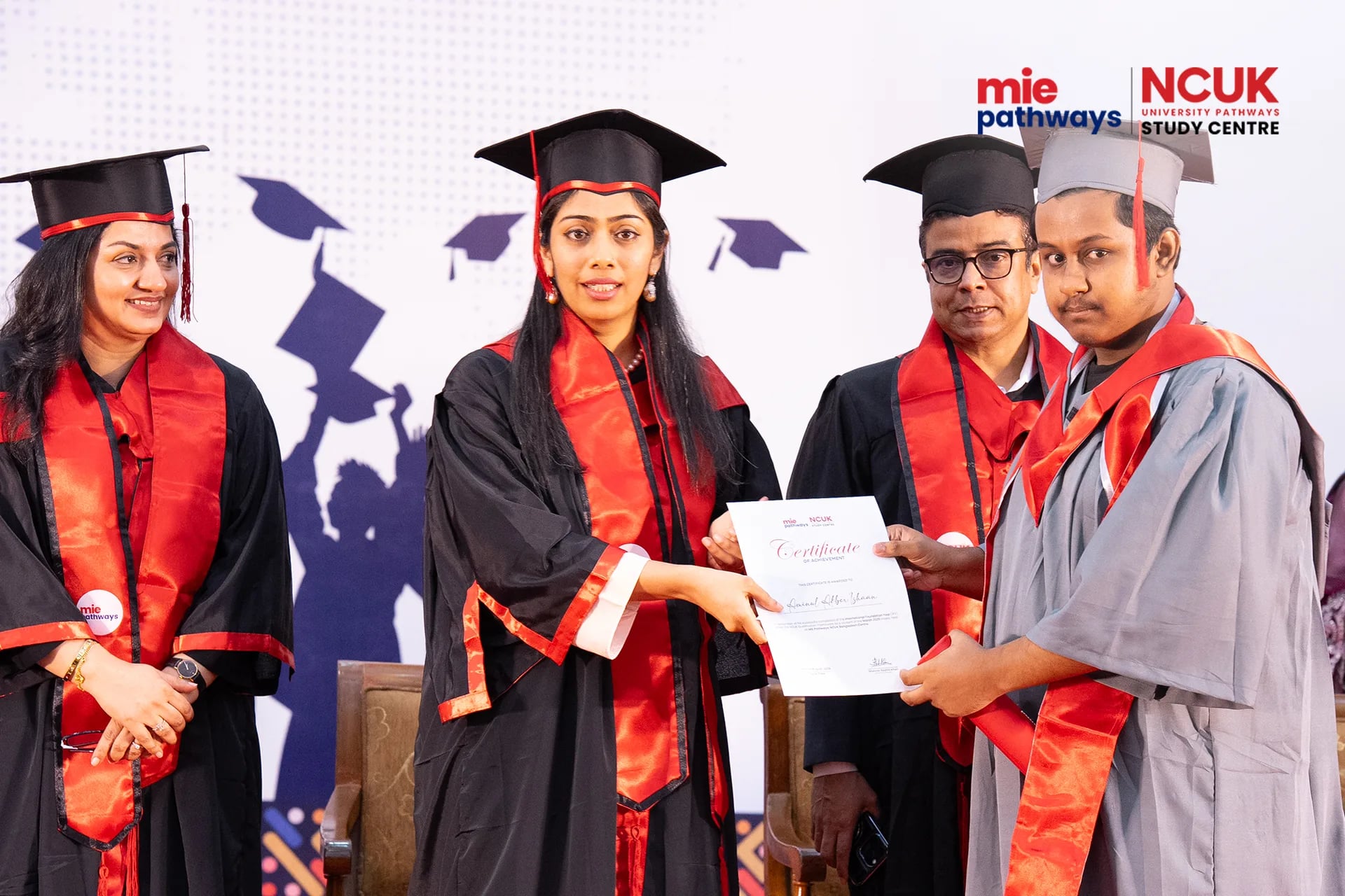 Graduates receiving their certificates at the NCUK Graduation Ceremony 2026 — photo 2