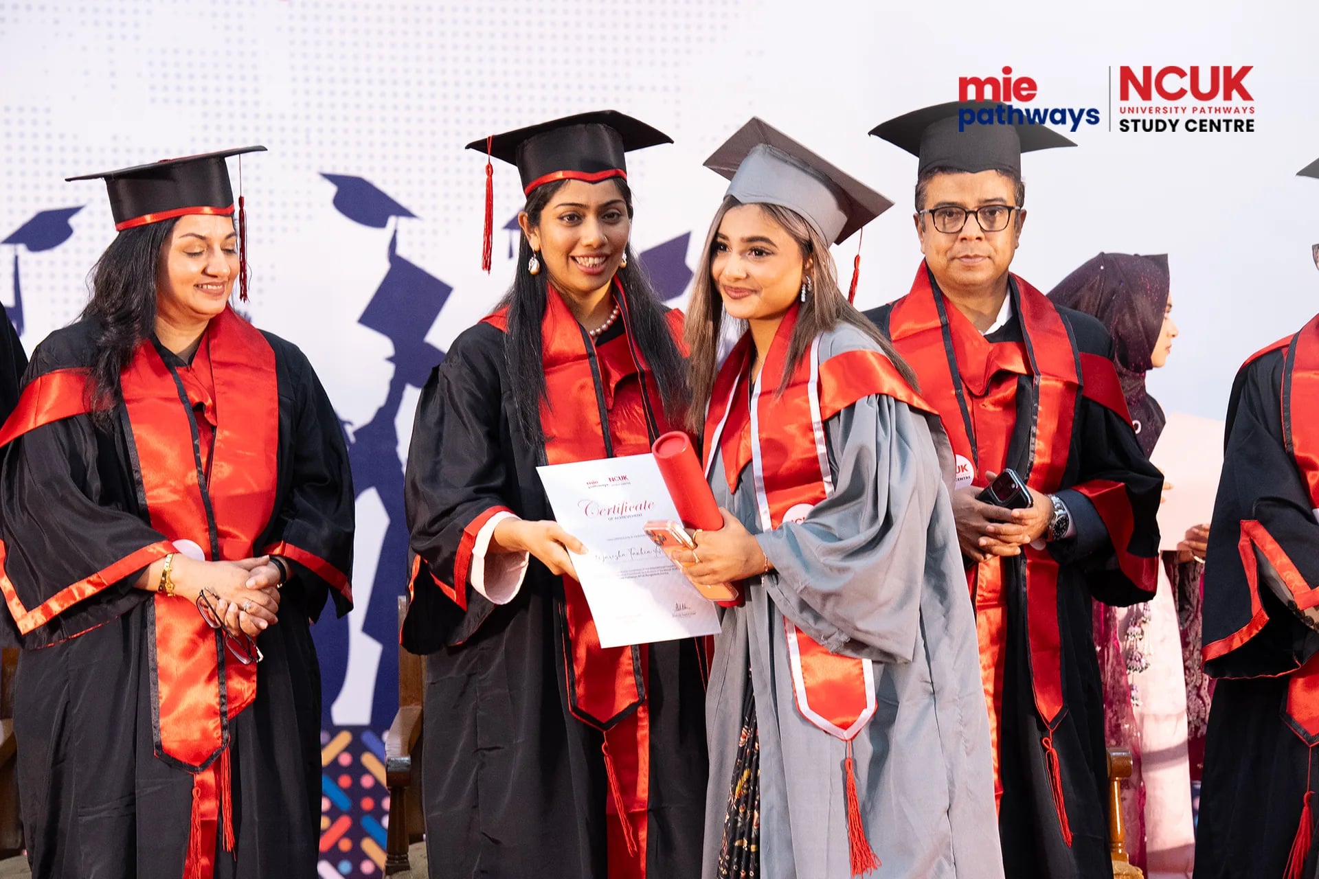 Graduates receiving their certificates at the NCUK Graduation Ceremony 2026 — photo 3