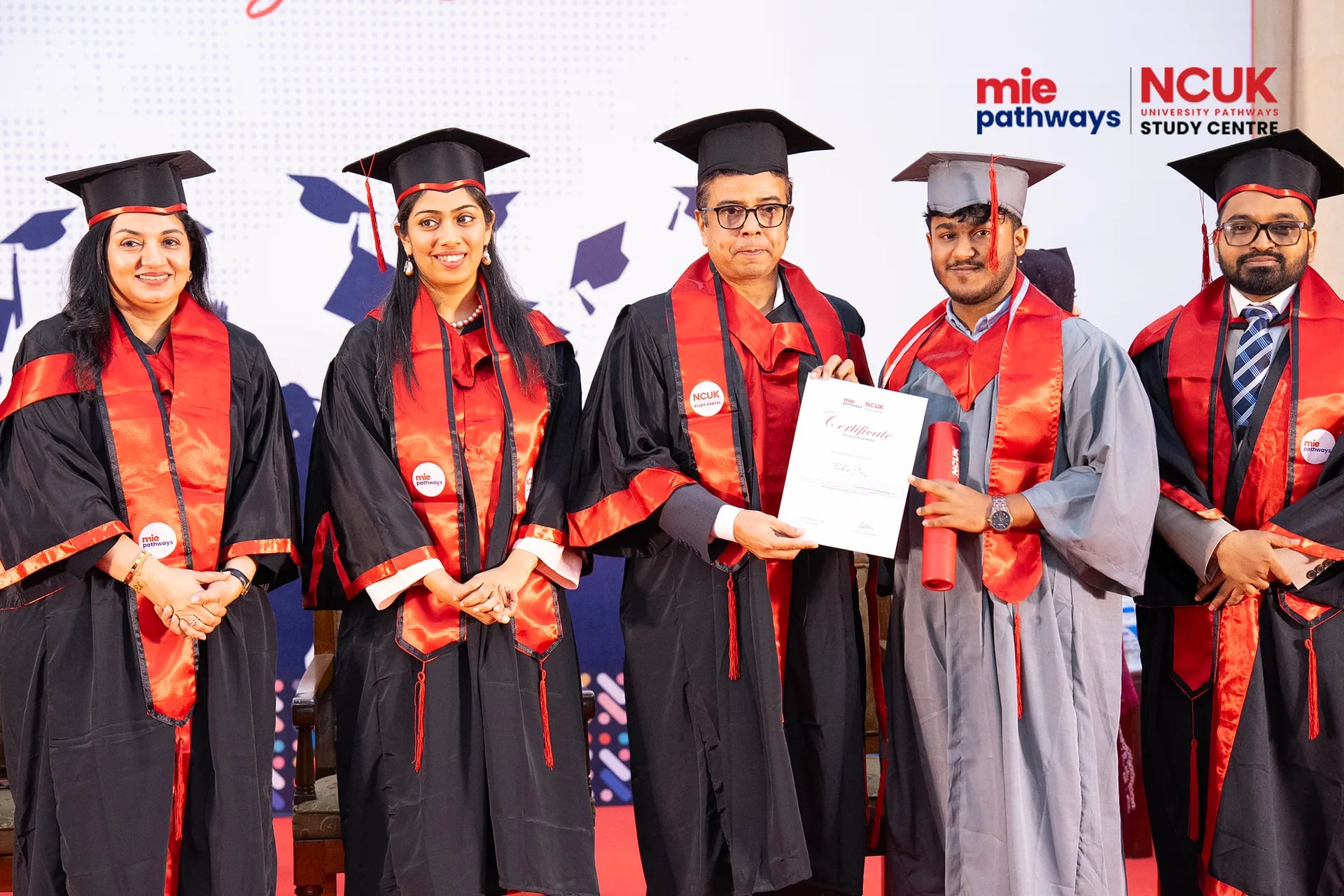 Graduates receiving their certificates at the NCUK Graduation Ceremony 2026 — photo 11
