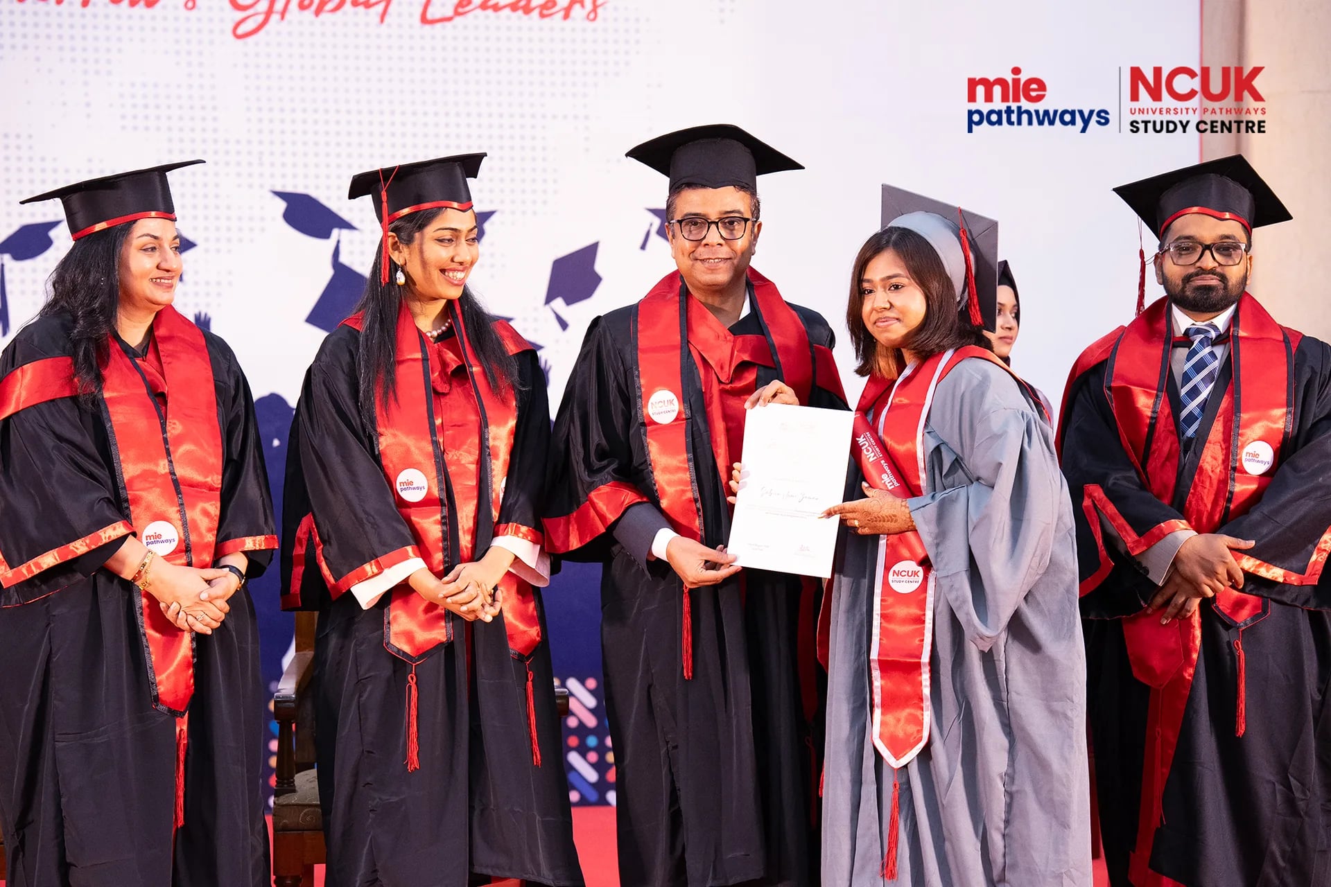 Graduates receiving their certificates at the NCUK Graduation Ceremony 2026 — photo 12